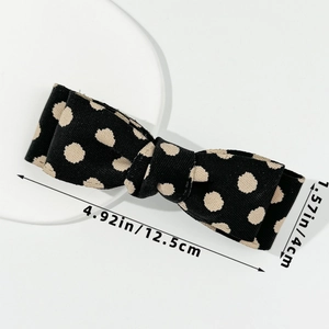 Polka dot bow hair clip detail with fabric texture and dimensions 12.5cm by 4cm