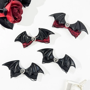 Detail of bat wing hair clips with lace trim and heart rhinestone for Halloween goth style