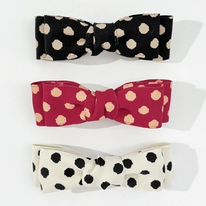 Three-piece set of retro polka dot bow hair clips in black, red and white fabric
