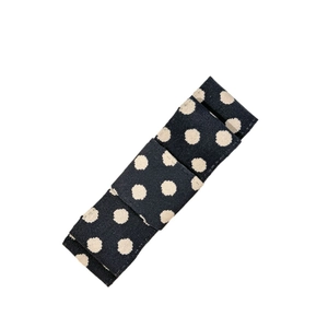 Chic black polka dot bow hair clip with textured fabric for stylish hair styling