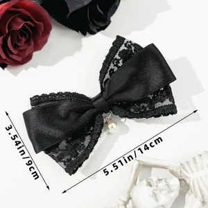 Detail of black lace and satin bow clip with white pearl drop on gothic dark rose background