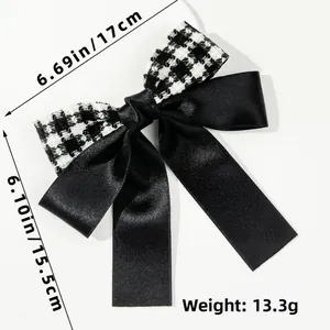 Detailed view of houndstooth bow hair clip with 17cm width and 15.5cm height