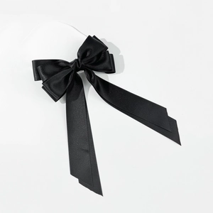 Elegant black double-layered satin bow hair clip with long ribbons on white background