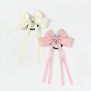 Sweet satin bow hair ties with heart charms and long ribbons in beige and pink colors