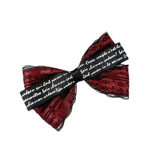 Gothic style red lace bow hair clip with black floral embroidery and lettered ribbon