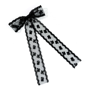 Elegant black lace bow hair clip with long ribbons and floral embroidery on white backdrop