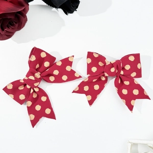 Polka dot bow hair clips in red with ribbon texture for elegant girls hairstyles
