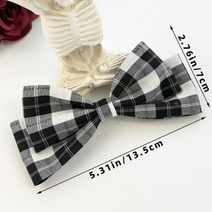 Detailed view of gingham bow hair clip with dimensions of 13.5cm by 7cm on a white background