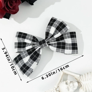 Classic black and white checkered bow hair clip detail with 16cm length measurements
