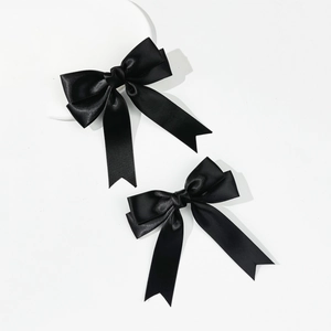 Elegant pair of black satin ribbon bow hair clips with long streamers for women