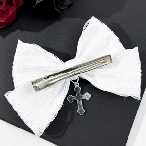 White lace bow hair clip with silver cross pendant in a gothic lolita aesthetic style