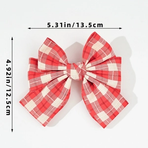 Detailed view of red and white plaid bow hair clip with 13.5cm width measurements