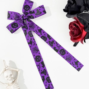 Halloween purple bow hair clip with pumpkin and bat patterns on white background
