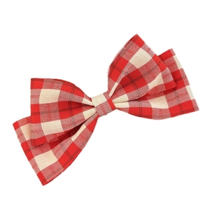 Sweet red and beige plaid bow hair clip with fabric texture on a clean white background