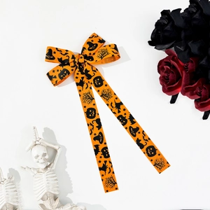 Halloween ribbon bow hair clip with orange pumpkin and bat prints on white backdrop