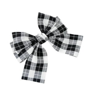 Classic black and white gingham bow hair clip with a minimalist spring clasp design