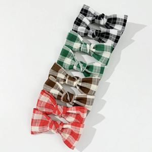 Set of four vintage plaid bow hair clips in black, green, brown, and red checkered fabric