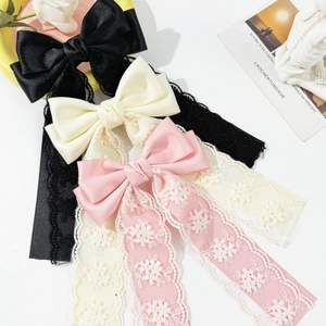 Elegant lace bow hair clips with long tassels in black, cream, and pink colors