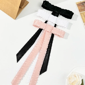 Three-piece ruffle bow hair clip set with long ribbons in black, white, and pink colors
