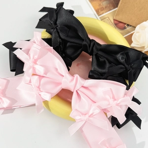 Pink and black satin bow hair clips with mini bow accents for elegant hairstyles