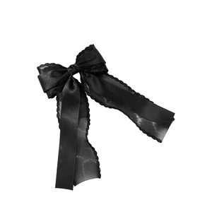 Elegant black satin ribbon bow hair clip with sheer mesh edges on a minimalist white background