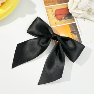 Elegant large black satin bow hair clip for women with a smooth and glossy silk texture
