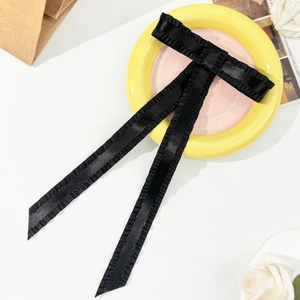 Elegant black satin ruffle bow hair clip with long ribbons for a vintage hair styling look
