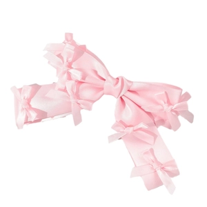 Pink satin bow hair clip with small butterfly accents on a white background