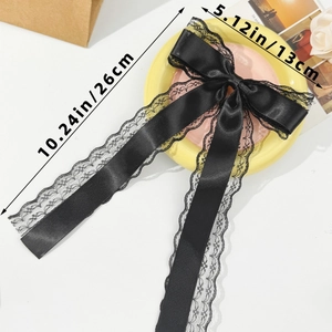 Detail of black lace bow hair clip with long ribbons and size dimensions in inches