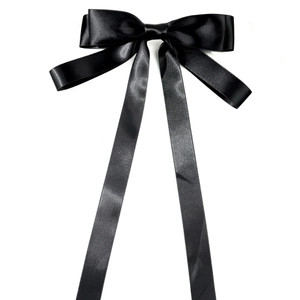 Elegant black satin bow hair clip with long streamers on a clean white background