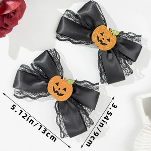 Halloween bow hair clips with orange pumpkin element and dimensions shown in inches and cm