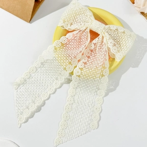 Elegant cream lace bow hair clip with long streamers and floral hollow texture