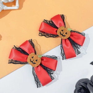 Detail of Halloween hair clips with red satin bows, black lace and orange pumpkin motifs