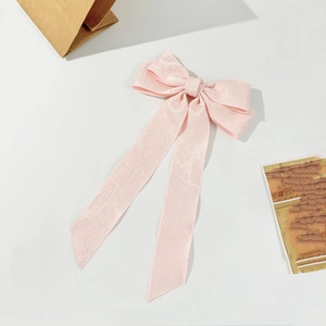 Light pink bow hair clip with long ribbons and jacquard texture for women's hair styling
