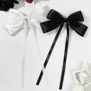 Elegant black and white ribbon bow hair clips with lace details and long flowing streamers