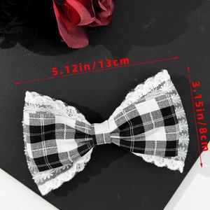 Detail view of a French vintage gingham bow hair clip with white lace trim, 13cm by 8cm