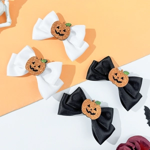 Halloween bow hair clips set with glittery pumpkin decorations for hair styling