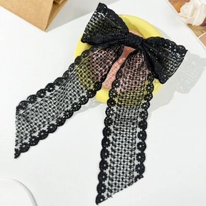 Elegant black lace bow hair clip with long ribbons featuring intricate floral texture