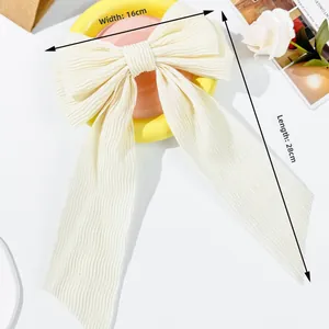 Detail of cream pleated ribbon bow hair clip showing dimensions 16cm width and 28cm length