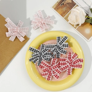 Three Gingham bow hair clips with scalloped lace edges in pink, black, and red colors