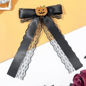 Detail of black lace bowknot hairpin with orange glitter pumpkin for Halloween styling