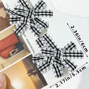 Detail of black and white checkered bow hair clips with size dimensions 6cm and 5.5cm