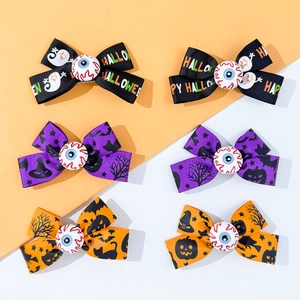 Detail of Halloween bow hair clips with spooky patterns and plastic eyeball centers