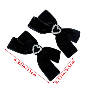 Detail view of black velvet bow hair clips with heart rhinestones and dimensions