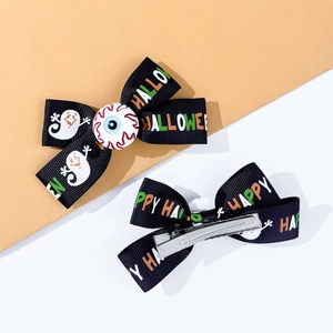 Detail of Halloween bow hair clip featuring ghost print and unique eyeball center decor