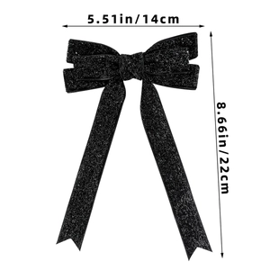 Macro shot of glittery black bow ribbon hair clip with size dimensions 22cm by 14cm