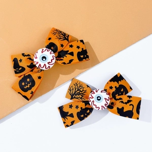 Detail of Halloween hair clips with orange pumpkin and bat prints and scary eyeball