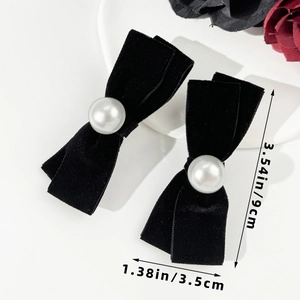 Detail of velvet bow hair clips with faux pearl accent and size measurements