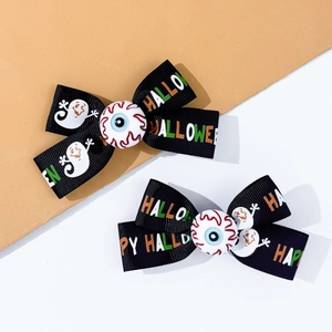 Detail of Halloween hair bows with Happy Halloween print and spooky eyeball center