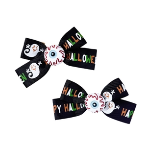 Halloween bow hair clips with spooky eyeball center and festive ghost pattern print